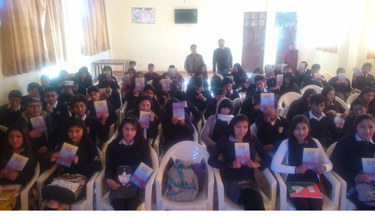 Students holding copies of The Tree That Weeps Blood